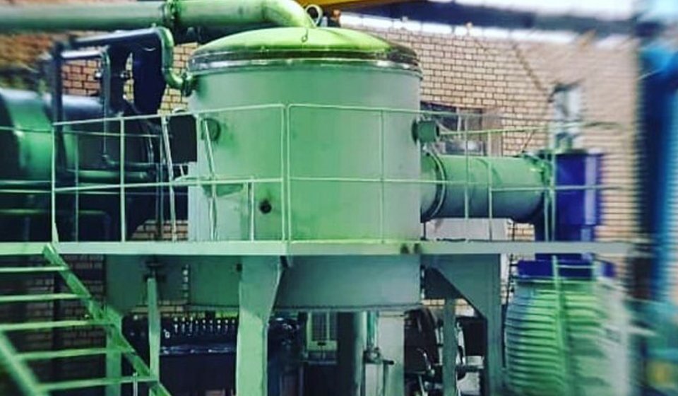 A workshop scene from the Datis years: the vacuum furnace vessel with its ducting and auxiliary equipment on an elevated platform.