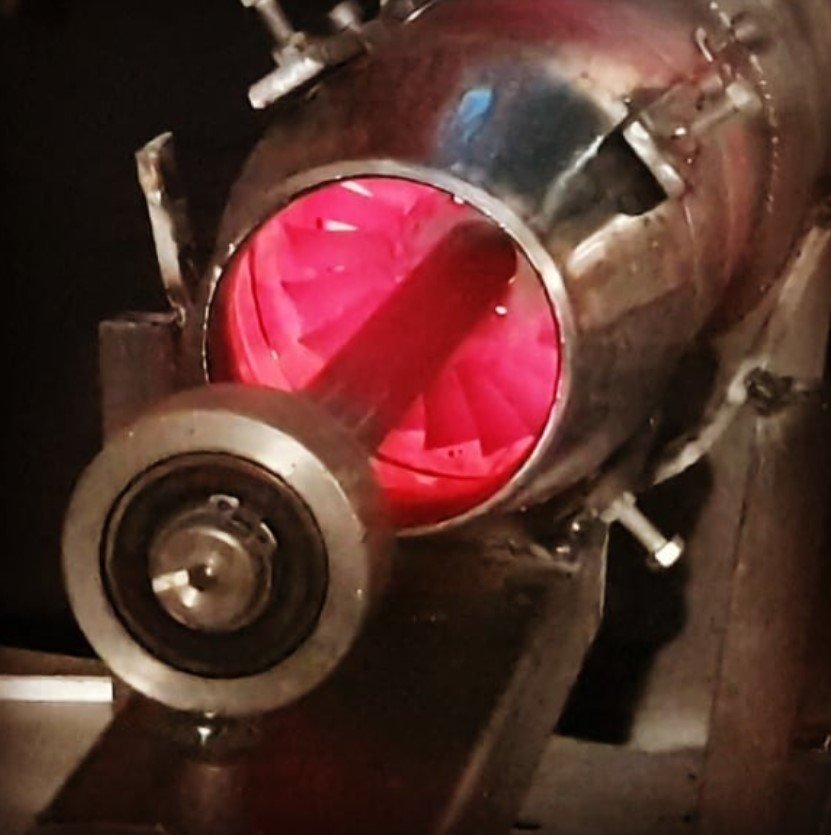 Close view of turbomachinery internals: shaft, discs and blading.